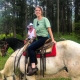 Margaret "Maggie" Strode horseback riding